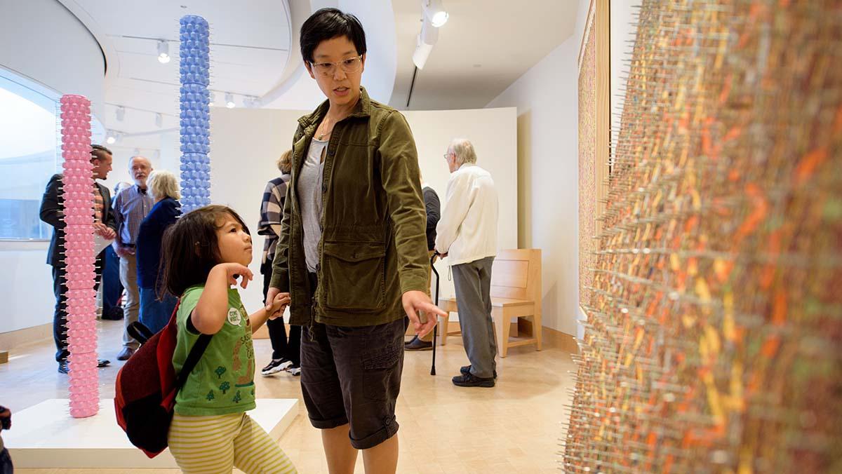 Parent and child at the James Watrous Gallery looking at art.