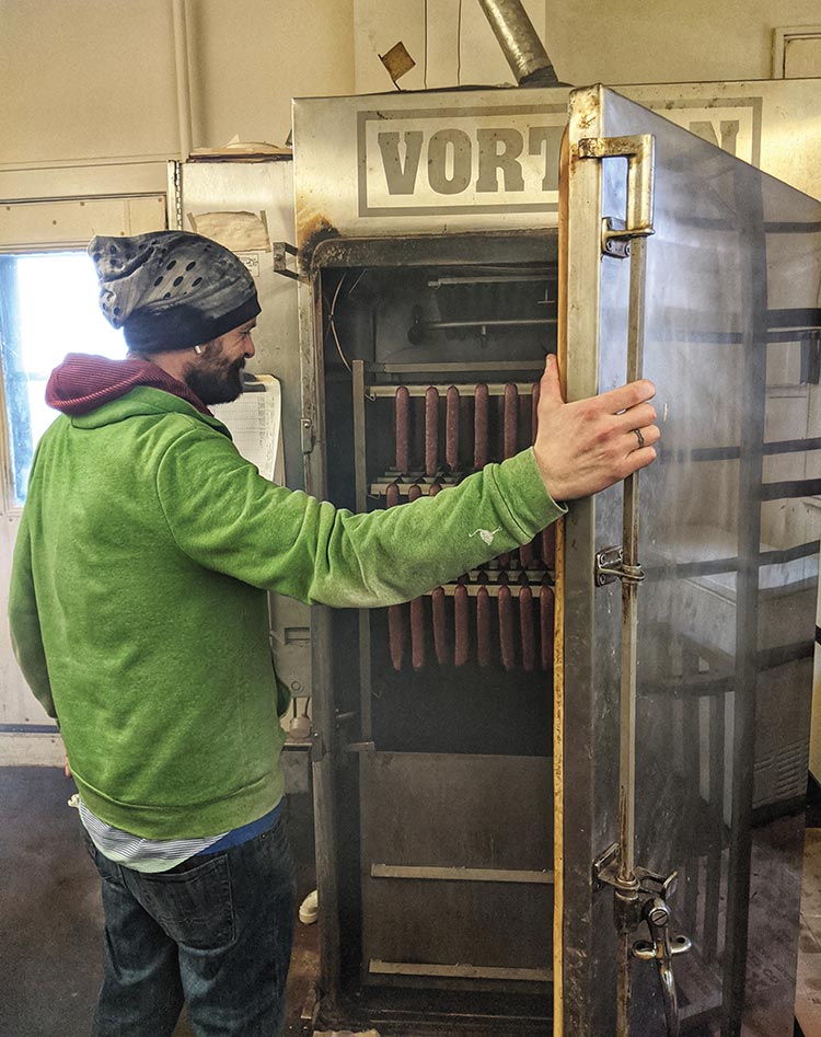 Chris Hessling checks the smoker at Ruef's Meat Market in New Glarus