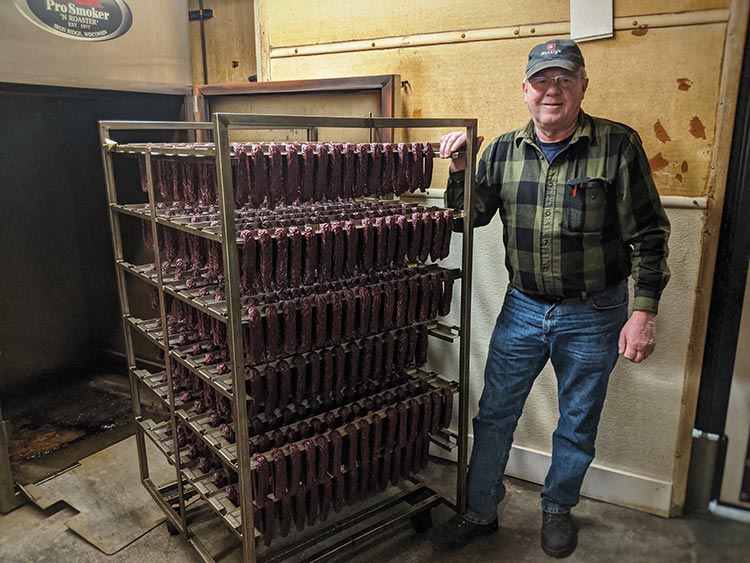 Dennis Hoesly with fresh-smoked landjaeger at Hoesly's Meats in New Glarus