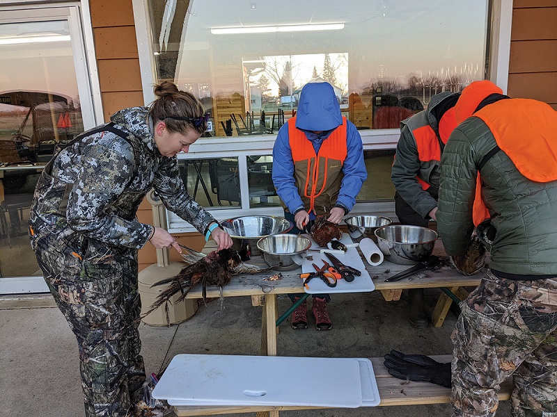Hunt for Food students clean their harvest at the Beaver Dam Conservationists facility in Dodge County. Photo by John Motoviloff Hunt for Food students clean their harvest at the Beaver Dam Conservationists facility in Dodge County.