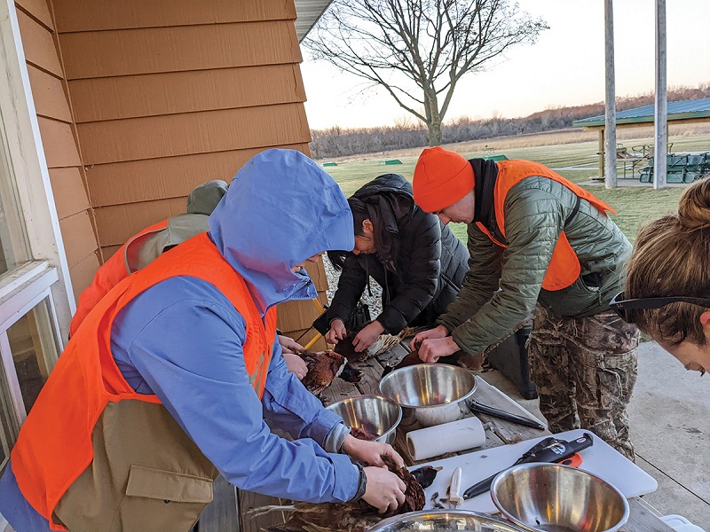 Hunt for Food students clean their harvest at the Beaver Dam Conservationists facility in Dodge County. Photo by John Motoviloff Hunt for Food students clean their harvest at the Beaver Dam Conservationists facility in Dodge County.